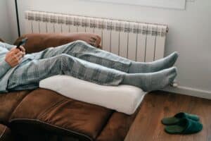 Man raising his legs on a recliner to help circulation and prevent restless leg syndrome.