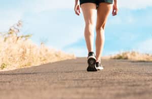Woman walking in shorts outside to boost circulation and prevent varicose veins